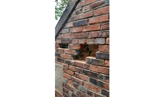 Charlottetown heritage home, mortar joints cut out, bricks earmarked for replacement cut out, awaiting replacement with era matched brick. ing